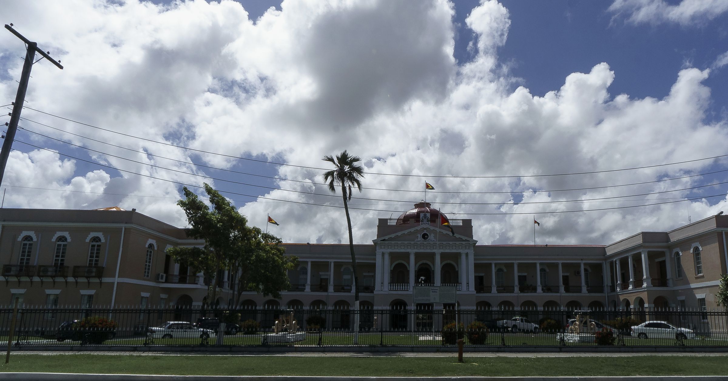 The Parliament Building in Georgetown, Guyana, under a wide sky.